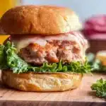 Delicious apple turkey burgers served on a plate with fresh ingredients.