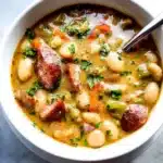 Delicious bean soup with sausage served in a bowl.