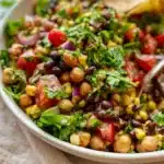 Fresh Chickpea Black Bean Salad with colorful vegetables and dressing