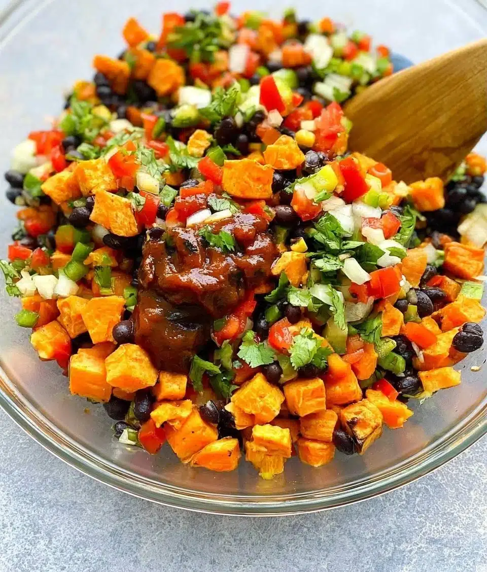 Chipotle sweet potato and black bean salad in a bowl with fresh ingredients