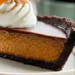 Decadent Chocolate Pumpkin Tart topped with chocolate drizzle and pumpkin seeds