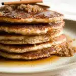 Fluffy cinnamon brown sugar pancakes stacked on a plate with syrup