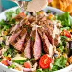 Delicious flank steak salad with fresh vegetables and dressing