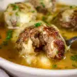 Delicious French Onion Meatballs served with melted cheese and herbs