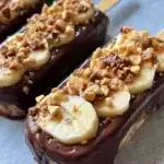 Frozen Banana Snickers dessert featuring bananas and Snickers chocolate.
