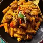 Delicious jerk chicken rasta pasta topped with fresh herbs and spices