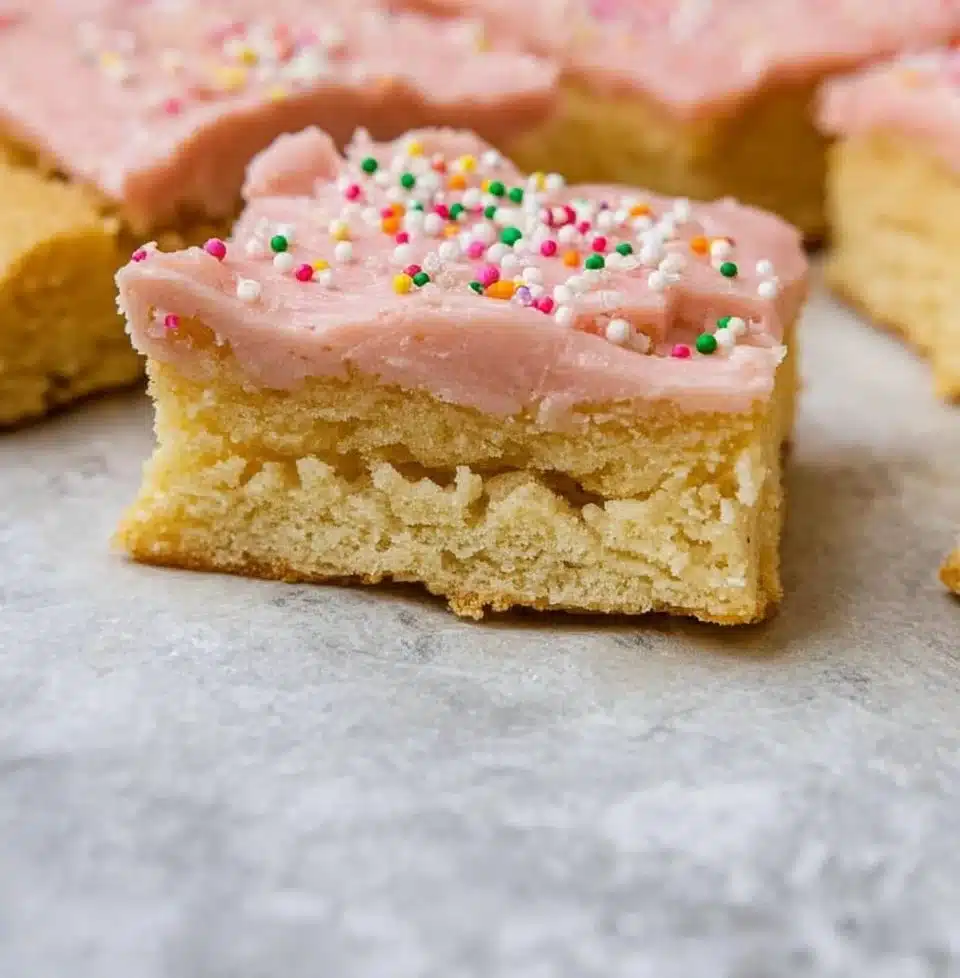 Delicious sourdough sugar cookie bars stacked on a plate.