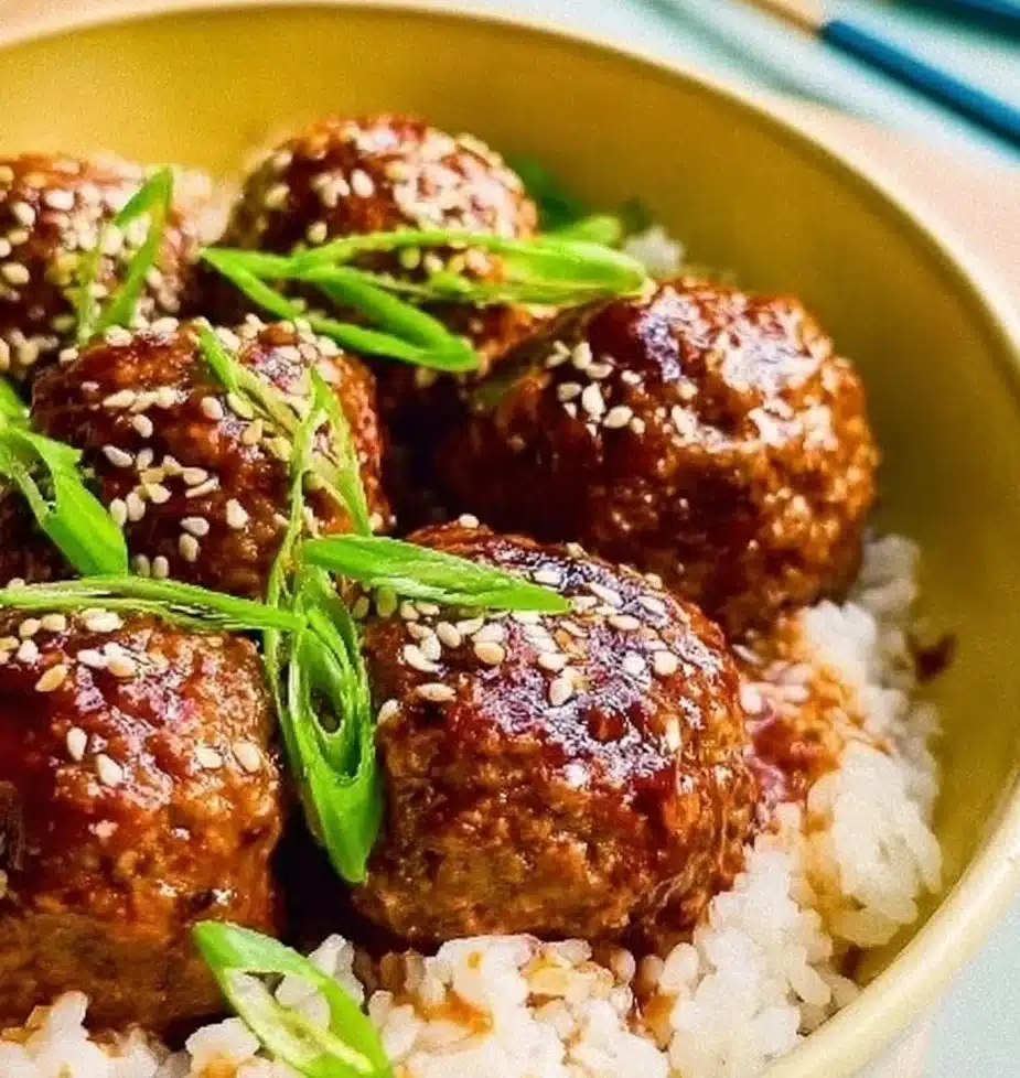 Sticky Asian Meatballs with a tangy sauce served on a plate.
