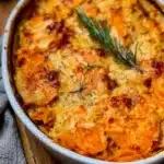 Deliciously baked Sweet Potato Gratin topped with cheese and herbs.