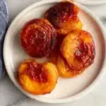 Delicious air fryer peaches served in a bowl with drizzled sauce