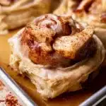 Homemade apple pie cinnamon rolls topped with icing and cinnamon