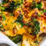 Baked Broccoli Bacon Cheddar Chicken served on a plate with herbs