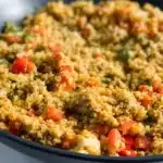 Plate of cauliflower rice with ground turkey, garnished with herbs, healthy meal