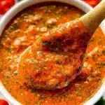 Fresh cherry tomatoes served with basil pesto in a vibrant dish.