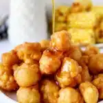 Golden brown corn fritters served with dipping sauce