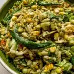 A vibrant bowl of Corn Orzo Salad with fresh vegetables and herbs.