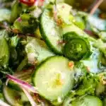Fresh and vibrant cucumber salad served in a bowl with herbs and dressing