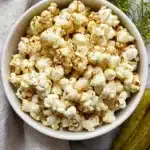 A bowl of Dill Pickle Popcorn seasoned with dill and pickle flavoring.