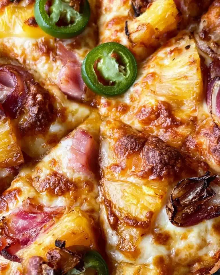 A slice of Hawaiian pizza topped with pineapple and ham on a wooden table.