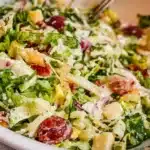 A vibrant La Scala Salad with fresh vegetables and dressing served in a bowl.