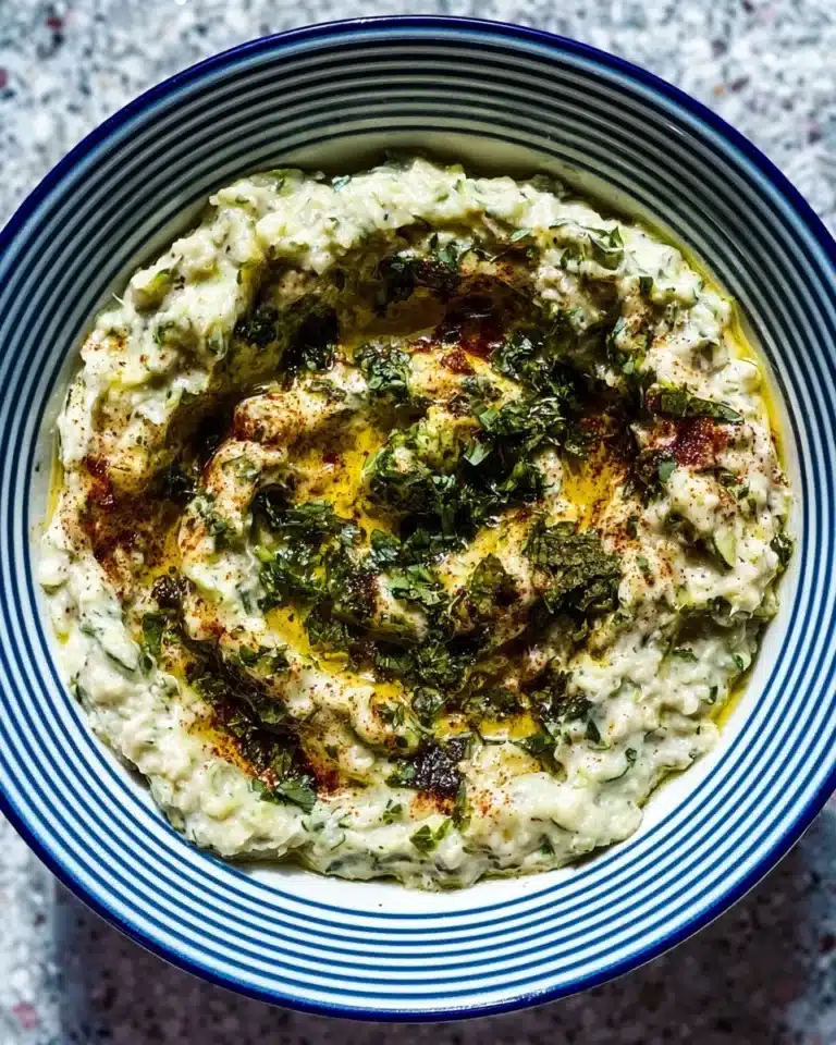 Creamy Mutabal Kousa dip made with zucchini and tahini, served with pita bread.