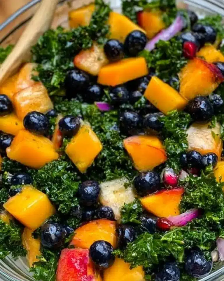 Peach and blueberry kale salad with fresh ingredients and vibrant colors