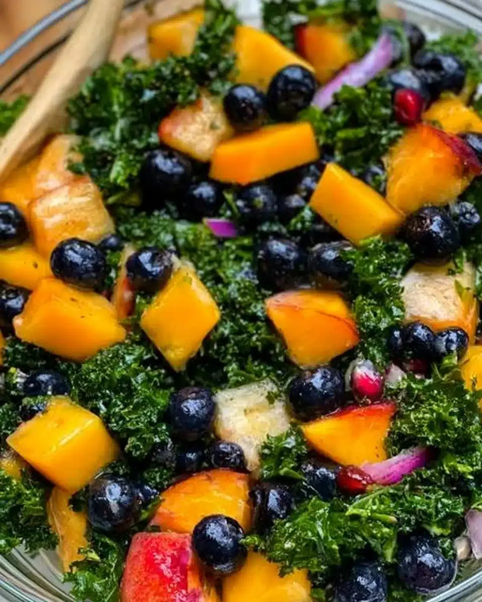 Peach and blueberry kale salad with fresh ingredients and vibrant colors