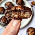 Delicious pecan pie bites topped with pecans and caramel drizzle.
