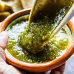 A bowl of fresh Salsa Verde with cilantro and lime garnish