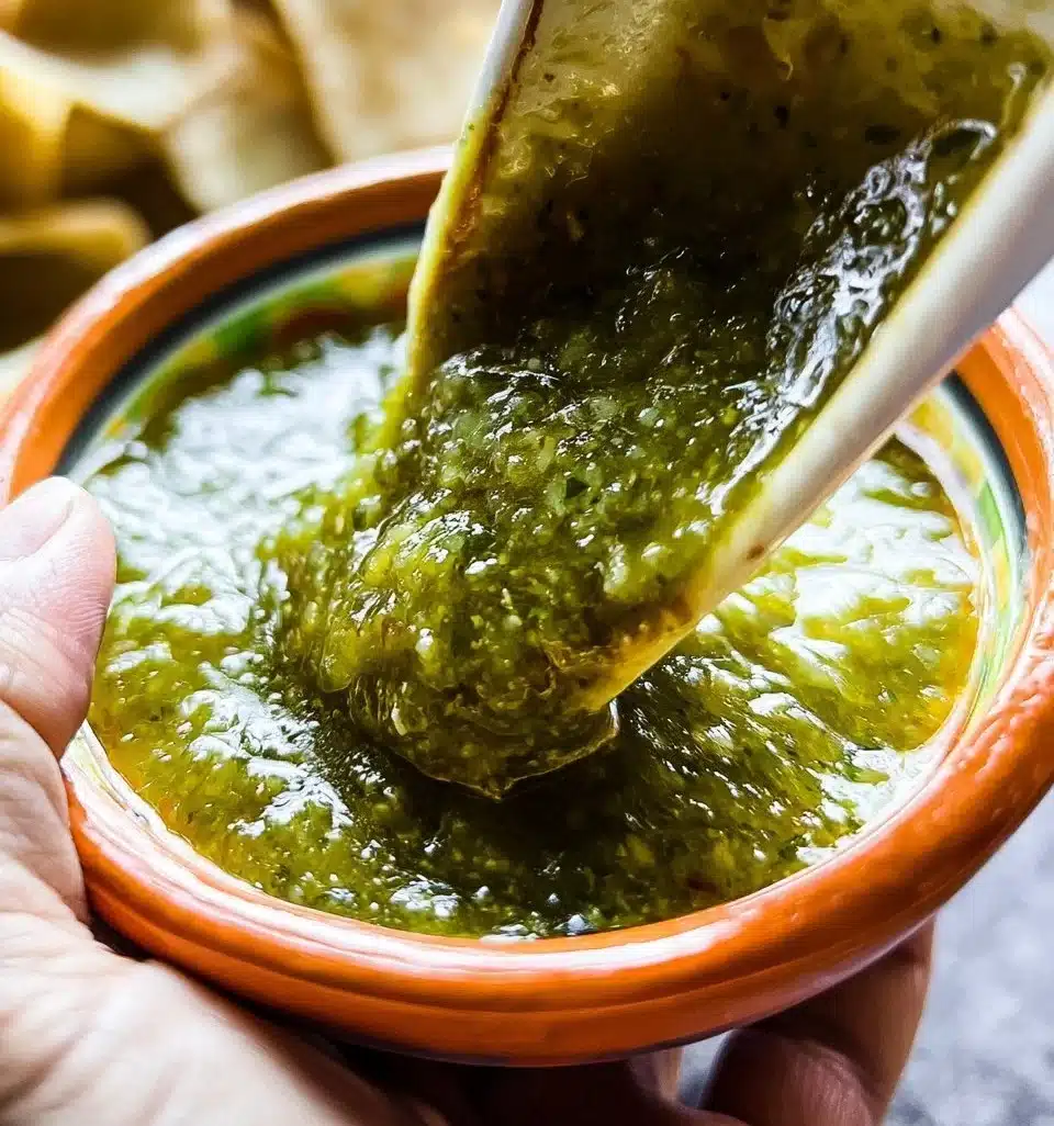 A bowl of fresh Salsa Verde with cilantro and lime garnish