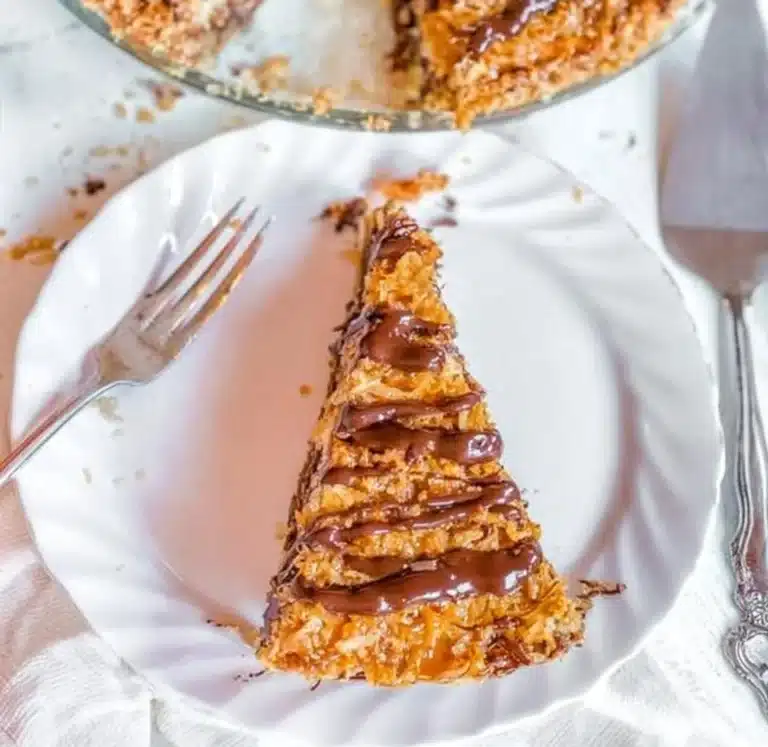 Delicious Samoa Pie with layers of chocolate, coconut, and caramel.