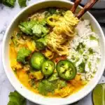 A colorful bowl of vegan curry with fresh vegetables and spices