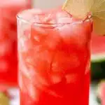 A glass of refreshing watermelon agua fresca with mint leaves