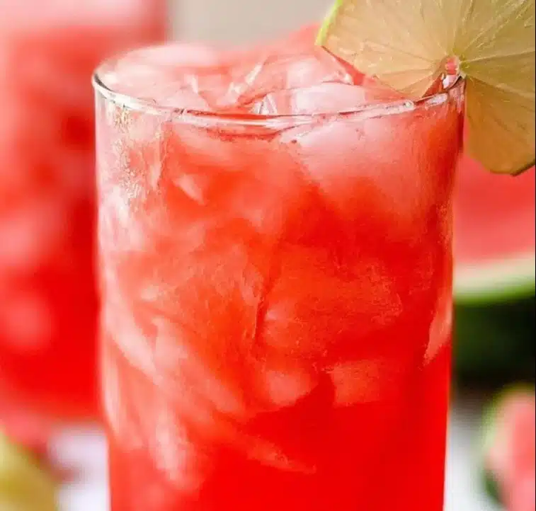 A glass of refreshing watermelon agua fresca with mint leaves