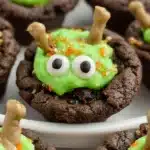 A plate of homemade Cauldron Cookies decorated for Halloween.