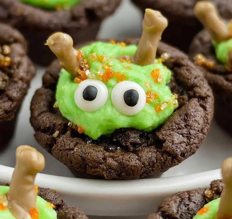 A plate of homemade Cauldron Cookies decorated for Halloween.