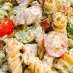 Bowl of Chicken Bacon Ranch Pasta Salad with fresh ingredients and dressing.