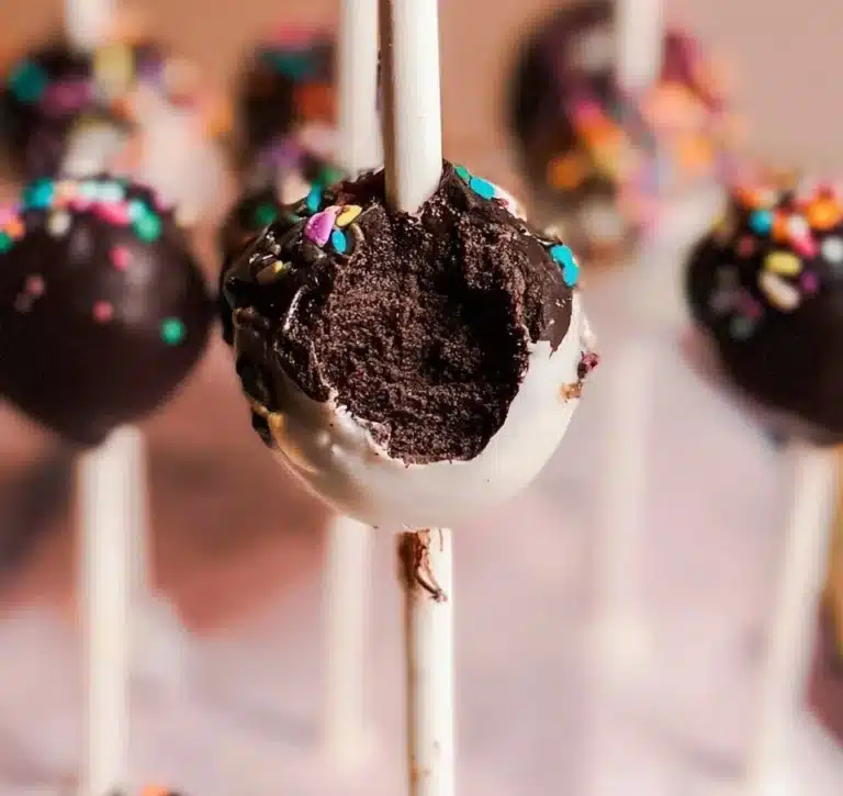 Delicious chocolate cake pops arranged on a decorative plate.