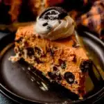 Slice of Cookies And Cream Cheesecake topped with crushed cookies