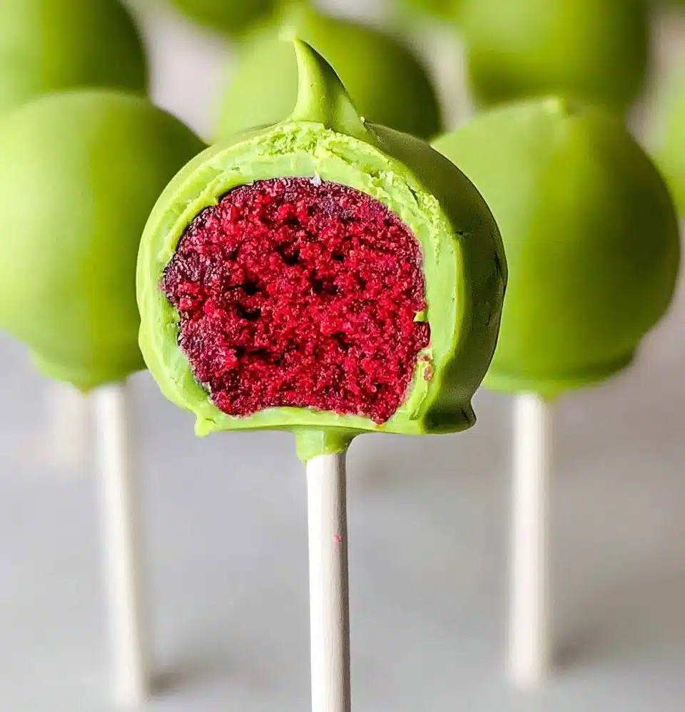 Festive Grinch Cake Pops decorated for holiday celebrations