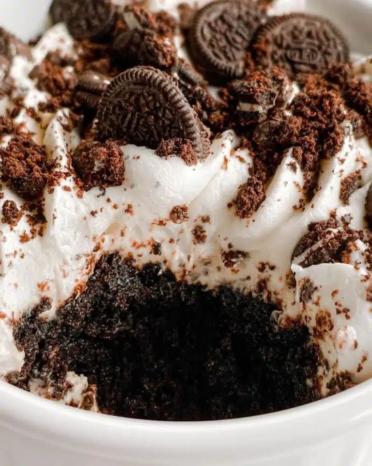 Delicious Oreo Mug Cake topped with crushed Oreos and chocolate drizzle
