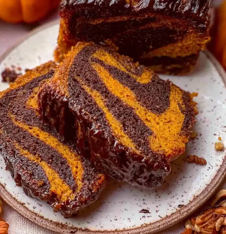 Pumpkin Marble Cake with chocolate swirls on a decorative plate