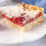 Delicious homemade Raspberry Coconut Bars served on a plate