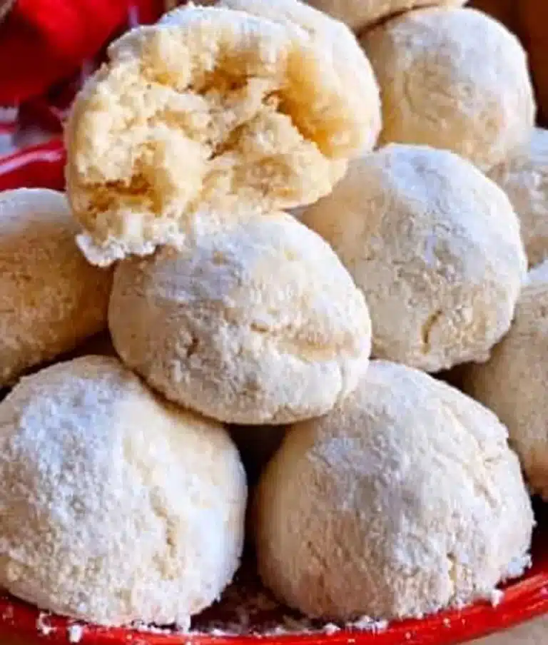 Delicious snowball cookies dusted with powdered sugar on a plate