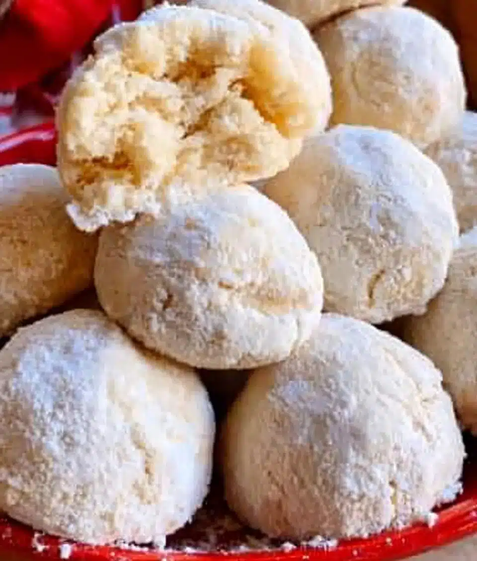 Delicious snowball cookies dusted with powdered sugar on a plate