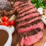 A beautifully arranged steak grazing board with assorted meats, cheeses, and garnishes.