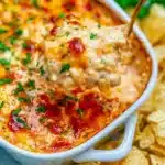 Deliciously creamy street corn dip served in a bowl with spoon - perfect for sharing.
