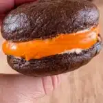 Delicious whoopie pies filled with creamy frosting between chocolate cakes.