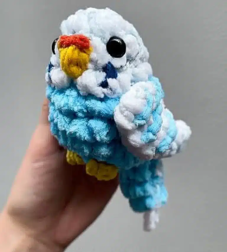 Colorful pocket parrots perched on a hand, showcasing their miniature size.